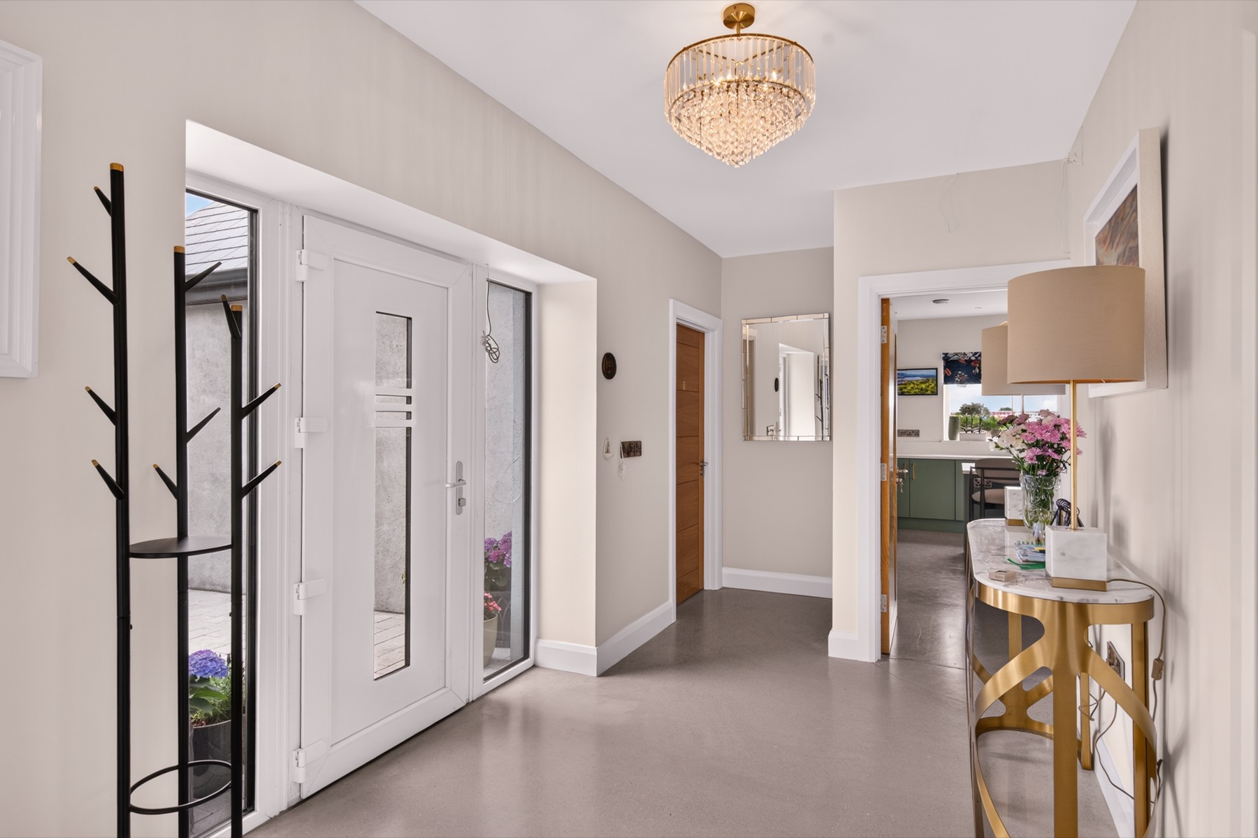 Bright entrance hall with crystal chandelier and polished floors